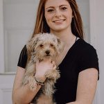 Girl with black shirt and small dog