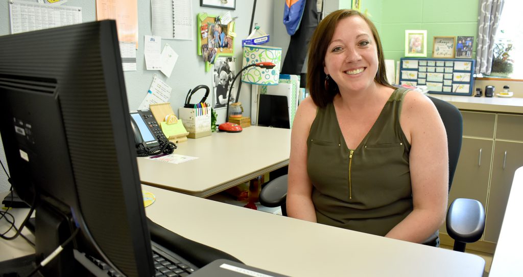 Female teacher sitting at desk