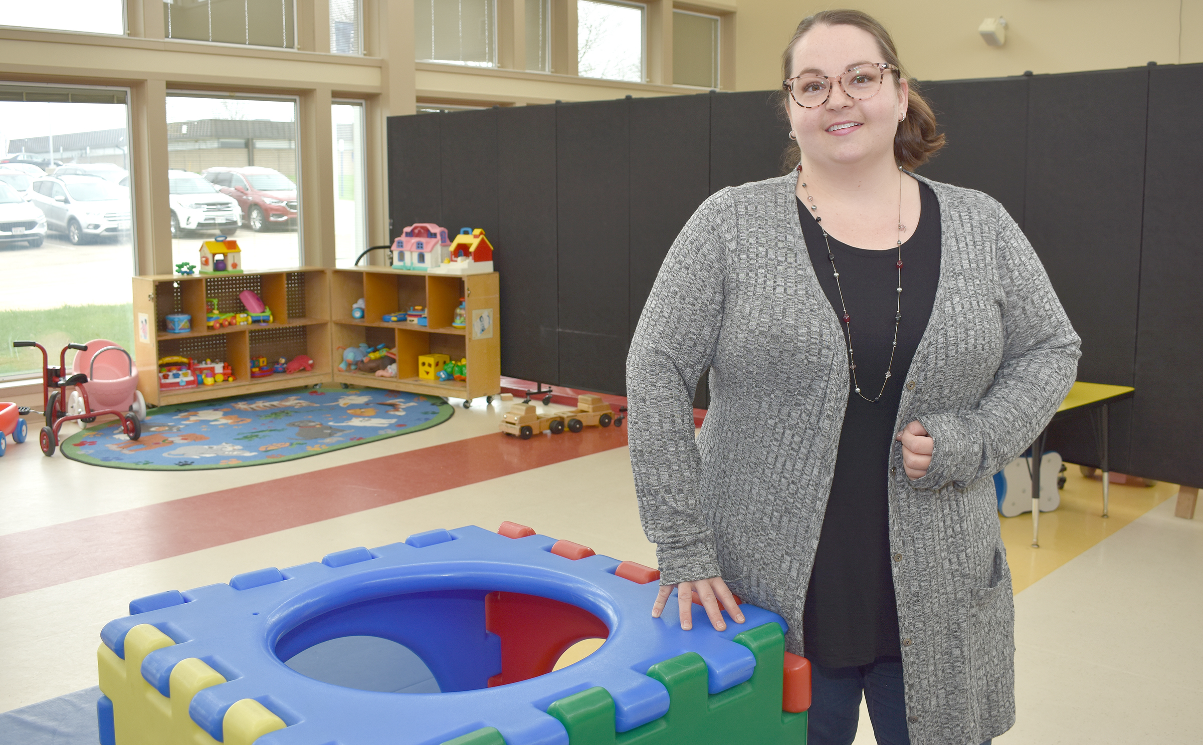 Female student standing in children's play area.