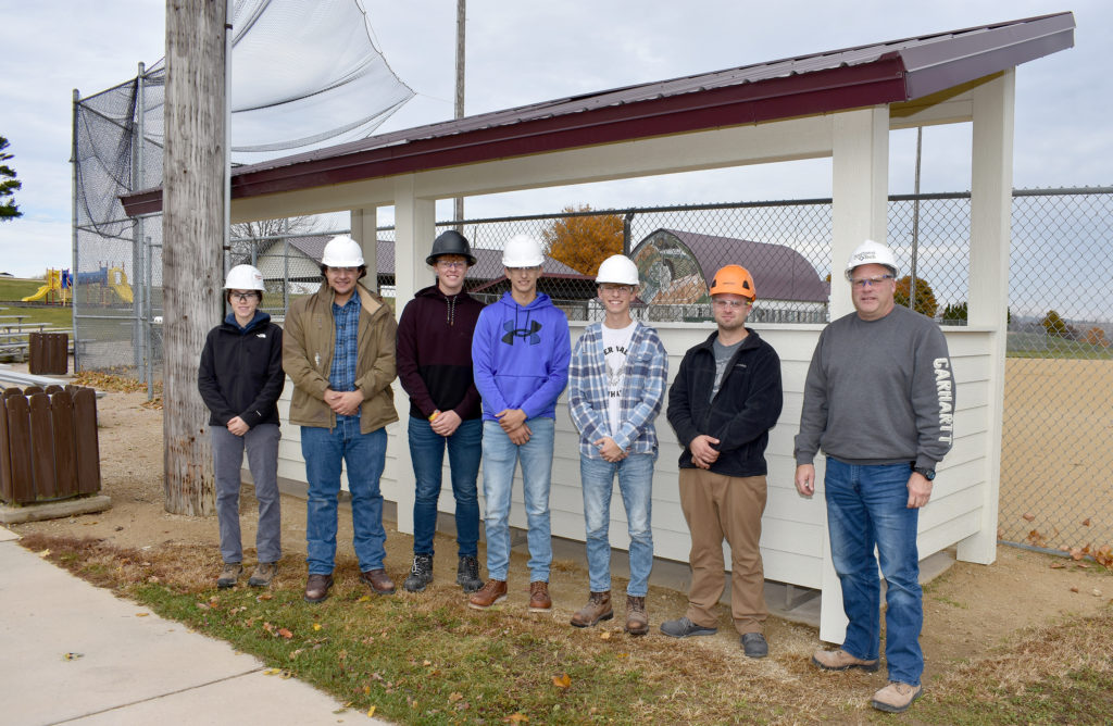 Students and instructor behind the dugout